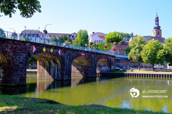 Old bridge in german Alte Brücke in Saarbrücken with the Saarbrücken castle in the background with t