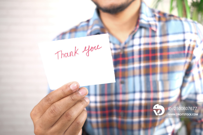 close up of man hand reading a thank you letter