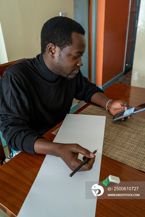 man holding a phone and pencil