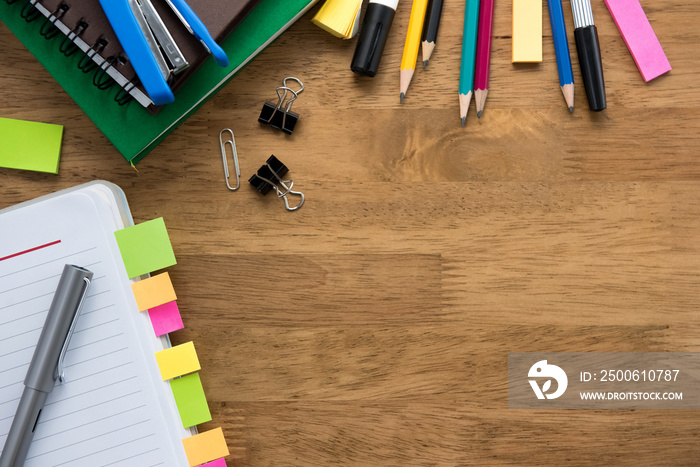 Colorful stationery on wooden table background