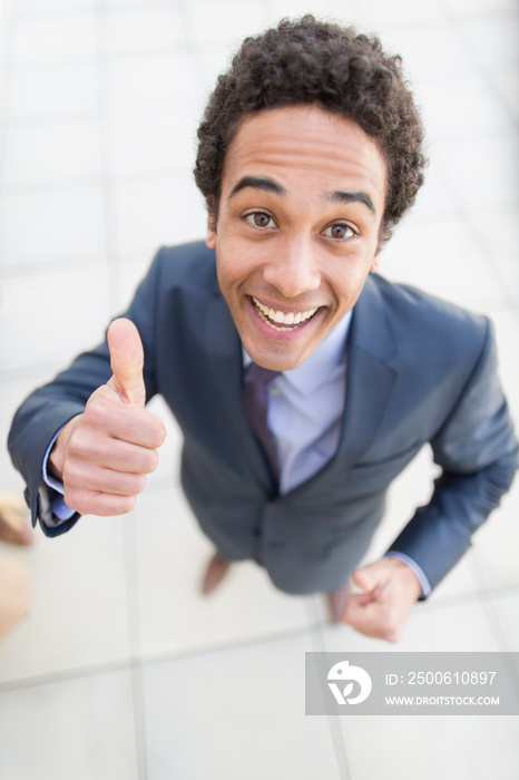 Portrait confident businessman gesturing thumbs up