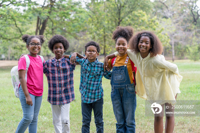 Portrait of African American childrens standing and looking at camera in the park