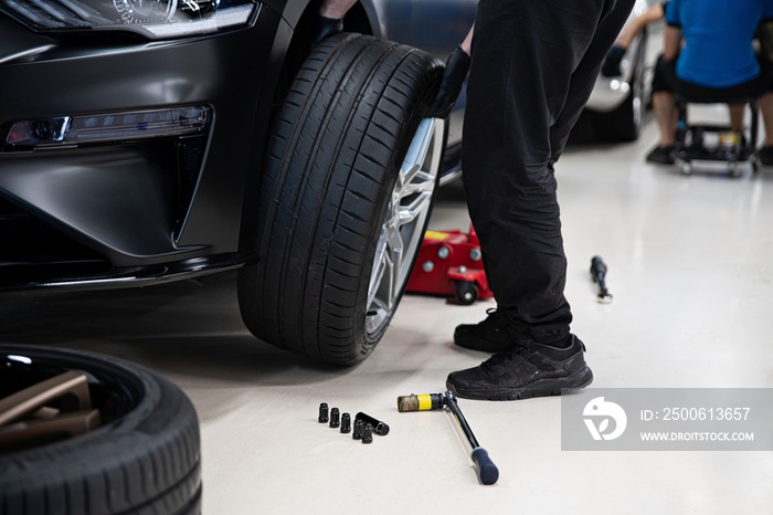 Mechanic changing wheel and tire. Car service