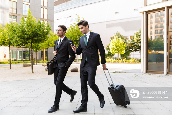 Two attractive young businessmen wearing suits