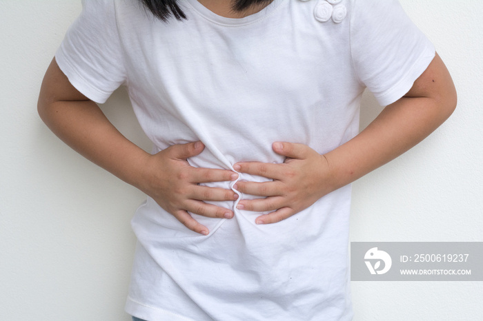 Woman Childs hands on her stomach with red spot as suffering on stomachache. Girl school kid suffer