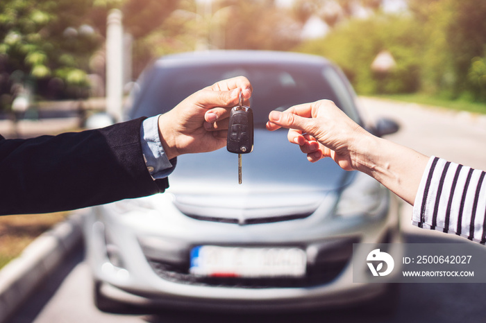 Hand of business man gives the car key