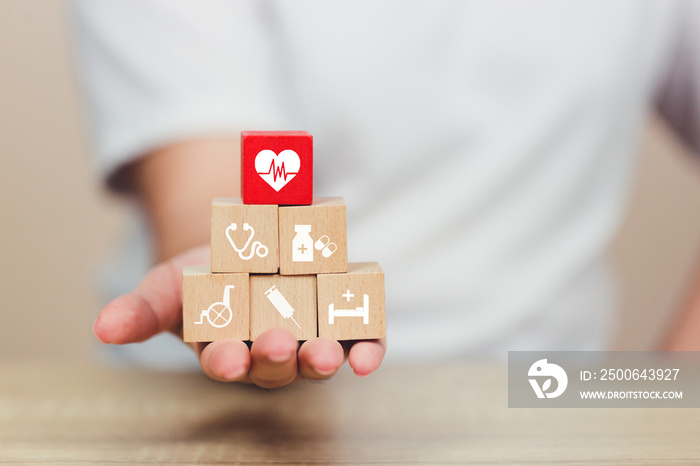 Health Insurance Concept,hand arranging wood block stacking with icon healthcare medical.