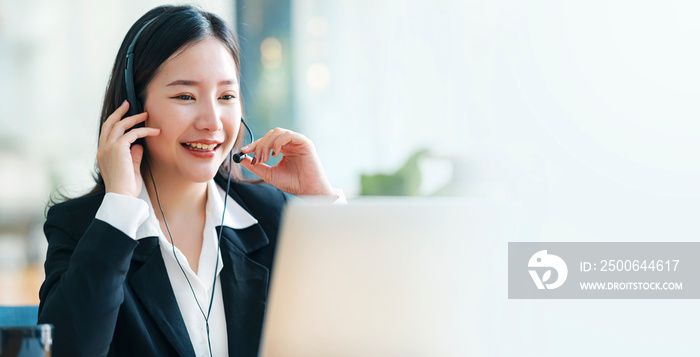 Female call center or customer support agent in broaden view panorama wearing headset while working 