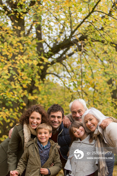 Portrait happy multi-generation family in autumn park