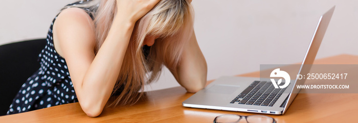 Frustrated and stressed woman at her laptop. Stress concept.