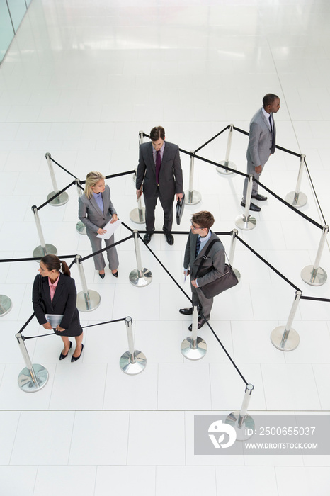 Business people among stanchion formation