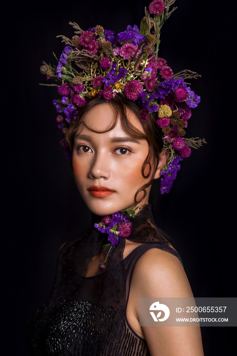Asian girls decorated with flowers on a dark background