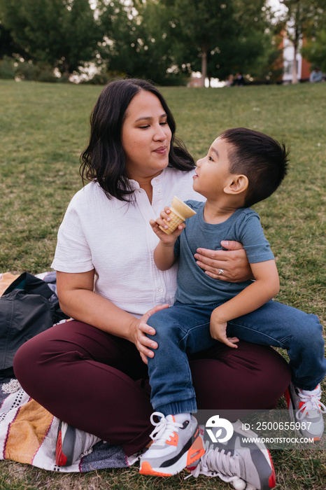 Mother and child eating ice cream in the park