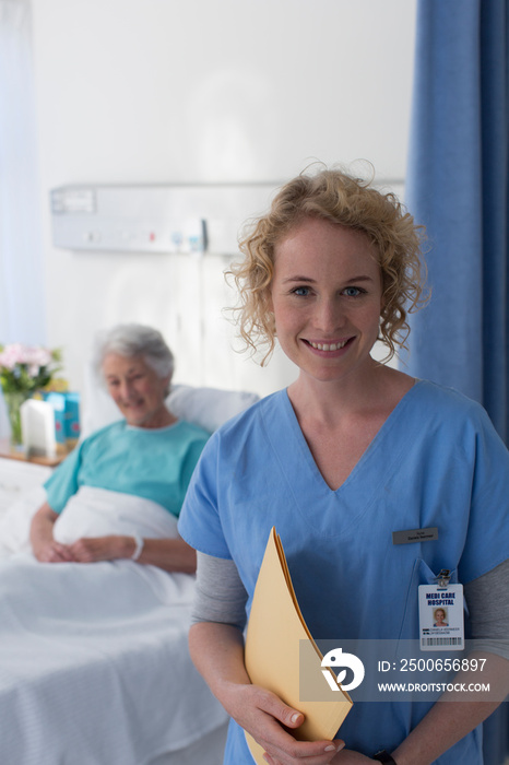 Portrait confident female nurse checking on senior patient in hospital room