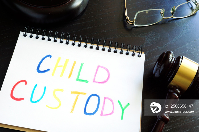 Child custody written in a note and gavel. Separation concept.