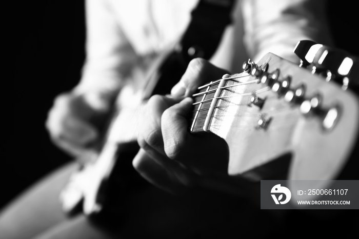 Black and white photo of man with guitar, closeup