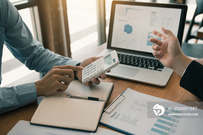 Two business partnership coworkers analysis strategy with discussing a financial planning graph and 