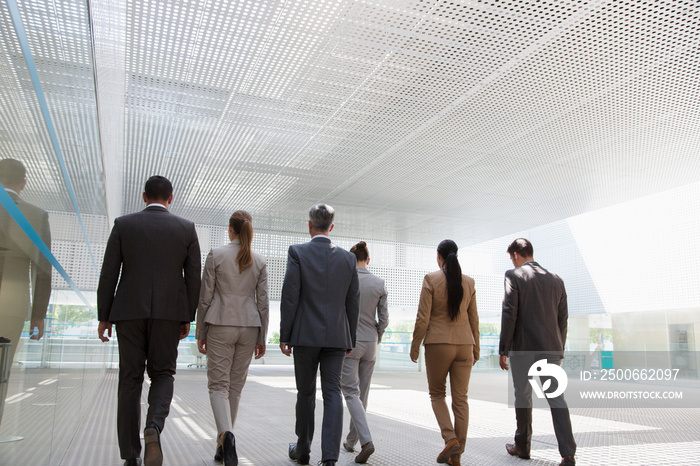 Corporate business people walking in modern office