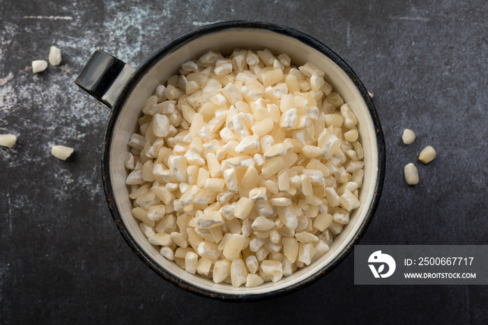 Uncooked Hominy in a Metal Cup