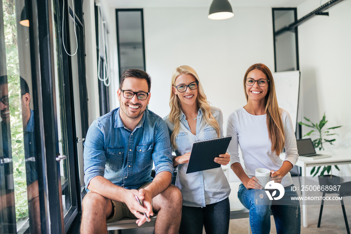 Portrait of creative business team in bright coworking office.