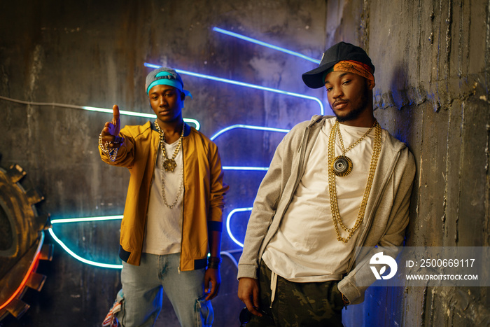 Two black rappers, neon lights on background