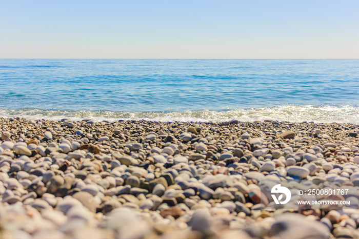 Mediterranean landscape in Antalya, Turkey. Blue sea, waves and pebble sandy beach