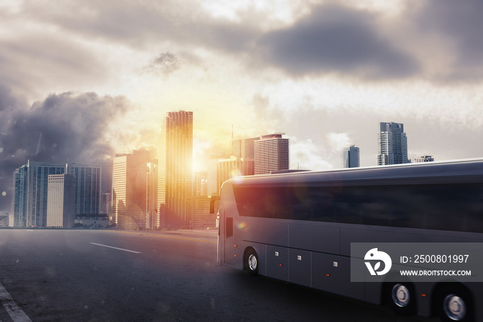 Black bus moving on the road in a cityscape at sunset