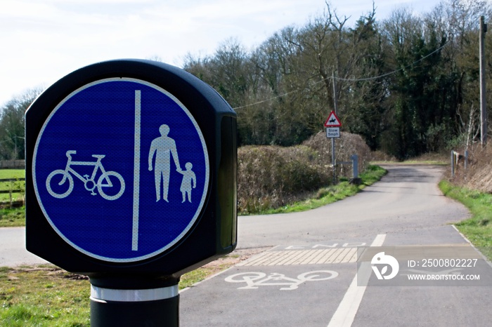 UK Circular shared cycling and walking sign with white text on a blue background. Room for text.