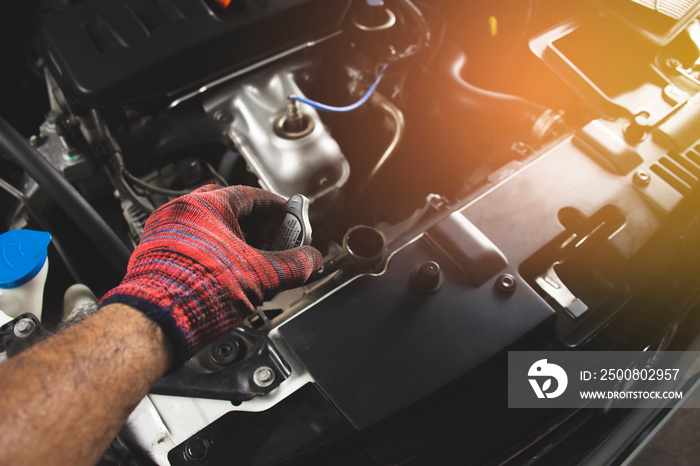 Mechanic man with red glove is opening radiator cap of a car,Automotive maintenance concept.