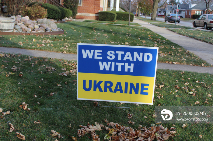 We Stand With Ukraine yard sign with fallen leaves in front of it in Des Plaines, Illinois