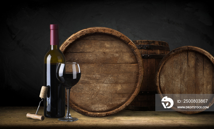 red wine bottle and wine glass on wodden barrel