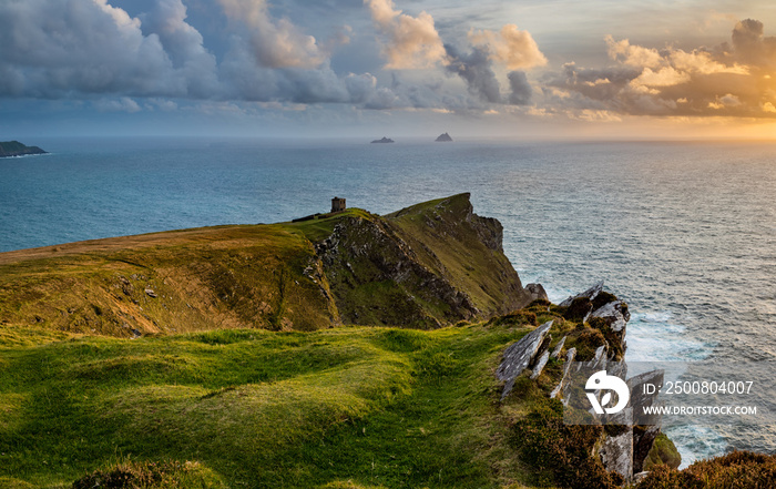 a viewpoint from bray head on valentia island in the ring of kerry in the south west coast of ireland during an autumn sunset showing the skellig islands and watchtower