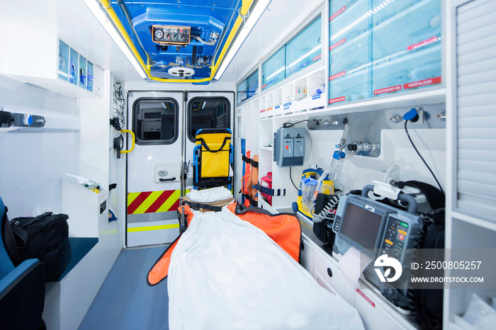 Ambulance interior with emergency equipment, stretcher and transfer chair. Emergency concept.