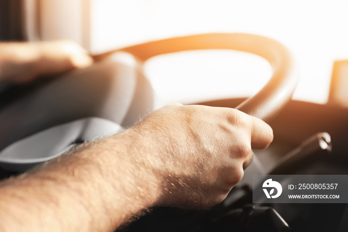 Young man driving modern truck, closeup