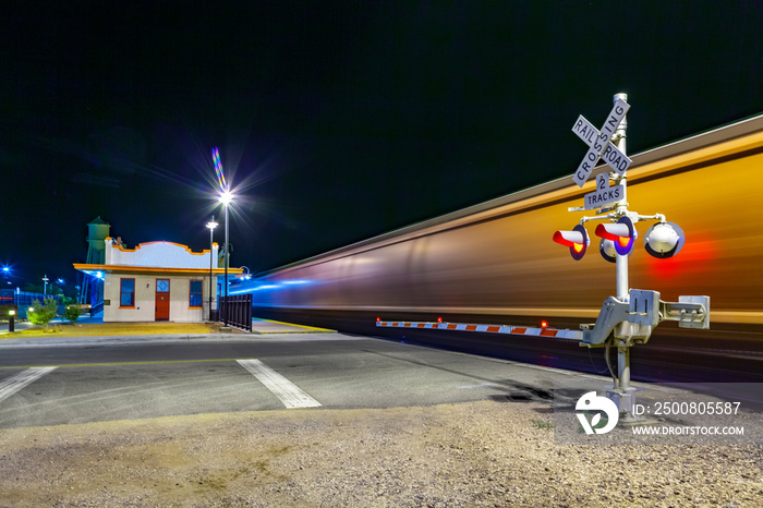 train passes at railroad crossing in the night. The Kingman station of the Santa Fee railroad opened in 1907 and is still in use