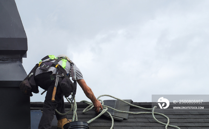 roof repair construction worker roofer man roofing security rope