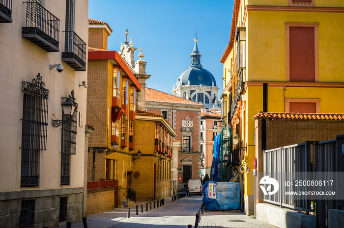 Colorful Madrid street and Almudena Cathedral view in Madrid, Spain