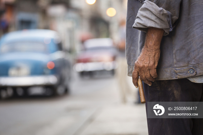 Man holding a cigar in the street of Havana, Cuba