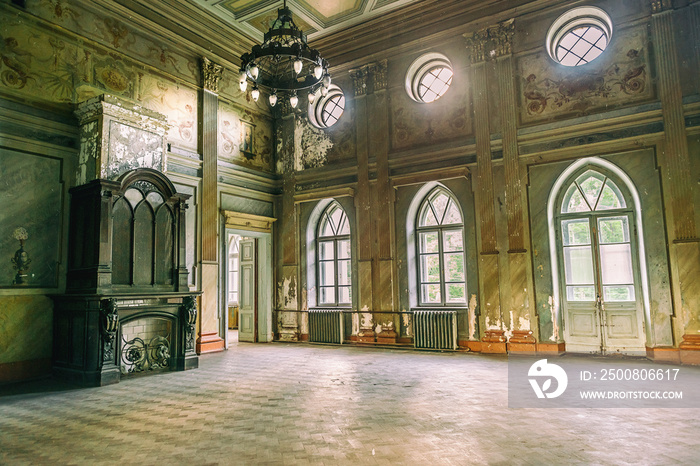 empty hall in Sharovsky Castle with chandelier and fireplace