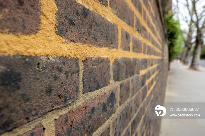 Repointing work on an old brick wall with mortar mix