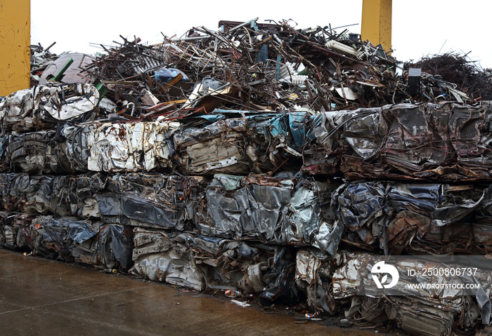 Junk yard with heap of metal waste