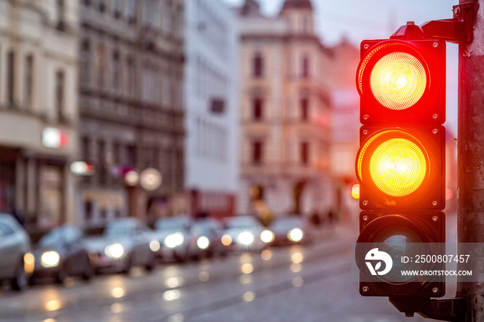 A city crossing with a semaphore. Red and orange light in semaphore