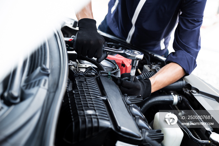 Automobile mechanic repairman hands repairing a car engine automotive workshop with a wrench, car service and maintenance , Repair service