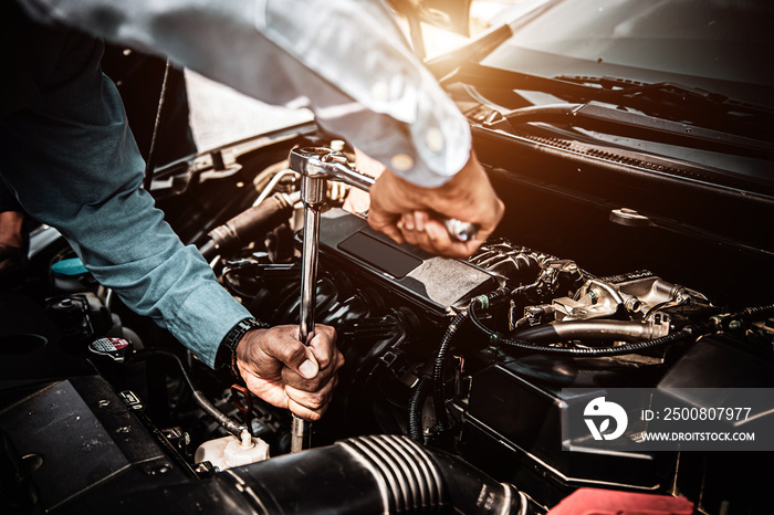 Car care maintenance and servicing, Close-up hand technician auto mechanic using the wrench to repairing change spare part car engine problem. Concepts of check and during periodic inspection service.