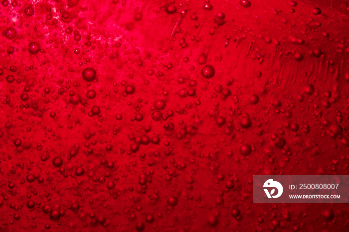 red bubble floating to the top of liquid