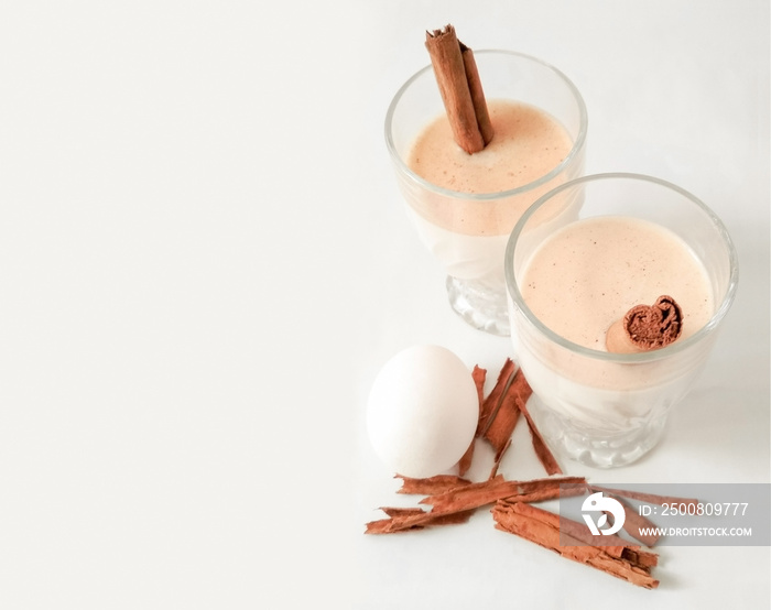 eggnog with cinnamon sticks and some ingredients