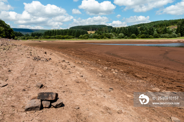 A dried up reservoir showing just dust and rocks during a summer heatwave (Llwyn-On Reservoir)