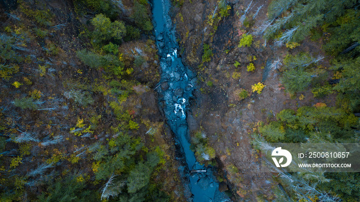 Aerial view looking down at a river running through the rugged mountain forests of western Washington state USA