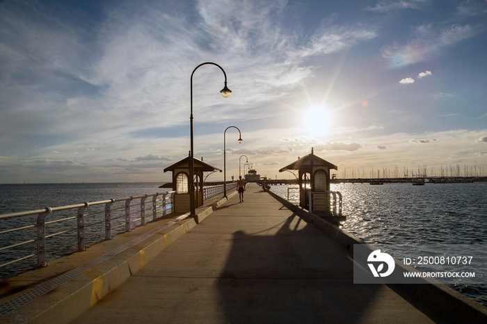 St Kilda Pier at sunset with the iconic Little Blue Pavilion at the end of the marina.