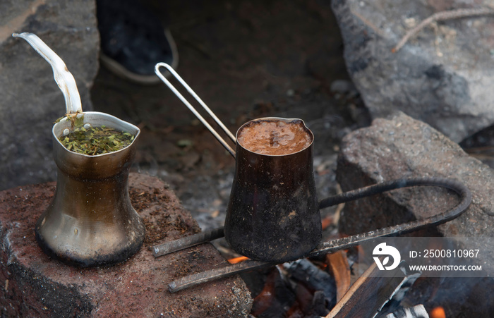 coffee and tea in nature on a cezve. in the fire